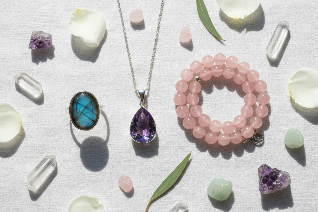 amethyst pendant, rose quartz bracelet, and labradorite ring on white linen — luxurious, editorial