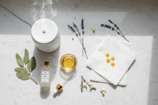Three methods of using essential oils shown side by side — an ultrasonic diffuser, a carrier oil and dropper for topical use, and a tissue for inhalation