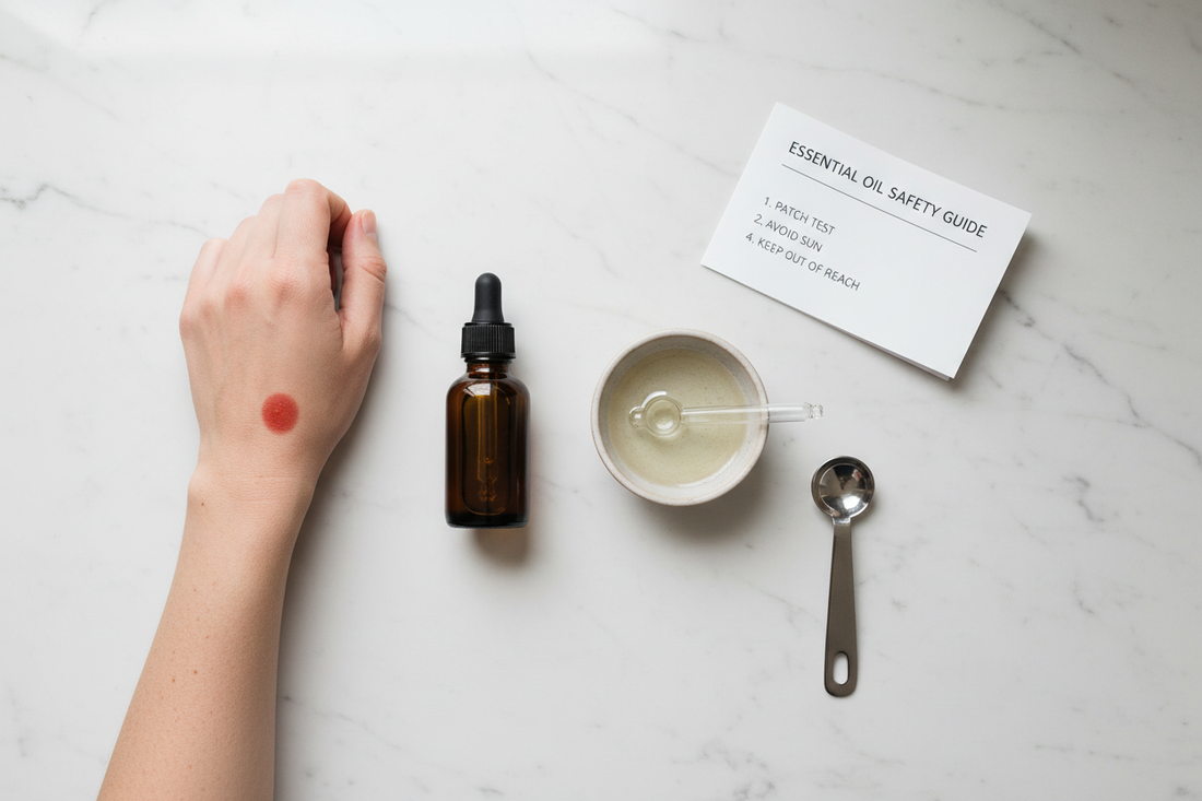 Essential oil safety essentials including a dark glass bottle, carrier oil, dropper and measuring spoon on a white marble surface