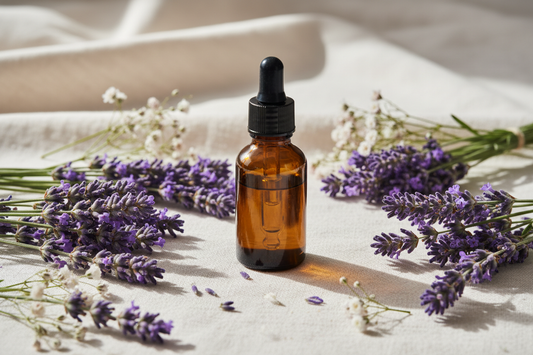 amber oil bottle with fresh lavender sprigs on linen — light, airy, spa feel