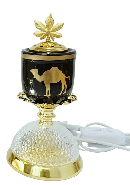Decorative lamp and burner with gold accents and a camel design on a white background